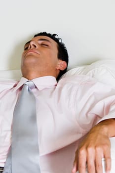 Close-up of a businessman sleeping in an armchair