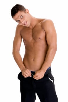 Portrait of a young man buttoning his pants