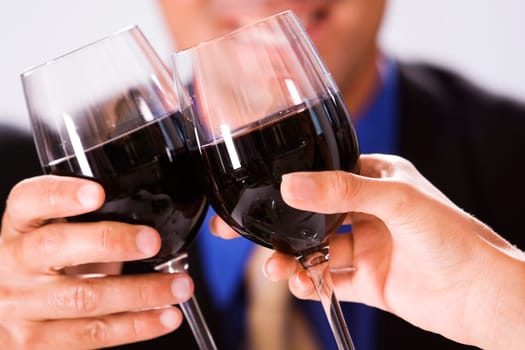 Close-up of two people toasting with wineglasses
