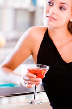 Close-up of a young woman holding a glass of martini