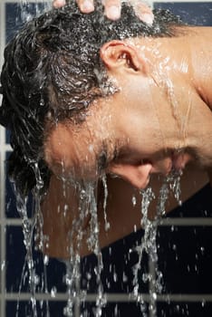 Close-up of a young man in the shower