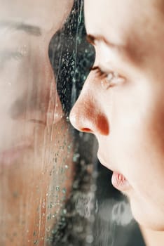 Reflection of a young woman on a glass surface
