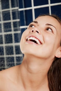 Close-up of a young woman looking up and smiling