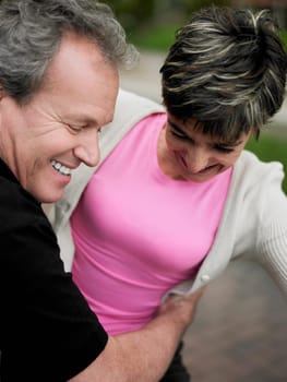 Close-up of a mature man embracing a mature woman and smiling