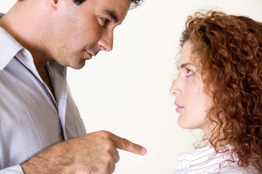 Side profile of a mid adult man pointing to a young woman