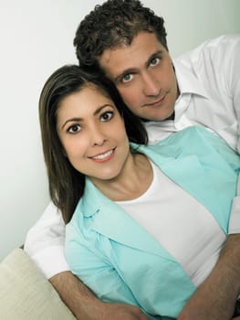Portrait of a mid adult man embracing a mid adult woman form behind