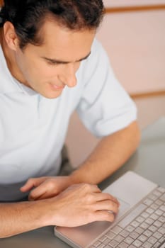 High angle view of a young man using a laptop