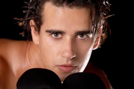 Portrait of a young man wearing boxing gloves