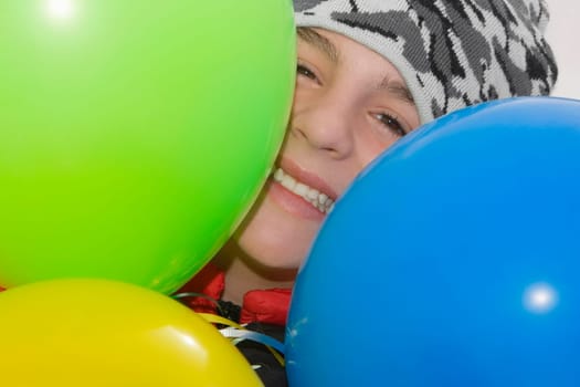Portrait of a teenage boy smiling with balloons