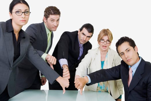 Portrait of two businesswomen and three businessmen showing thumbs down sign