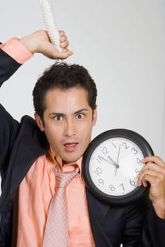 Portrait of a businessman holding a noose and a clock
