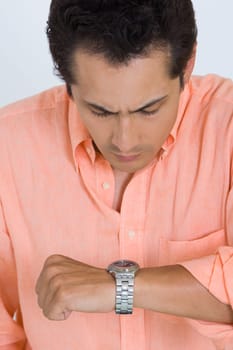 Close-up of a young man looking at his watch
