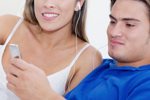 Close-up of a young couple listening to an MP3 player