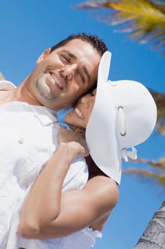 Mid adult woman embracing a mid adult man from behind