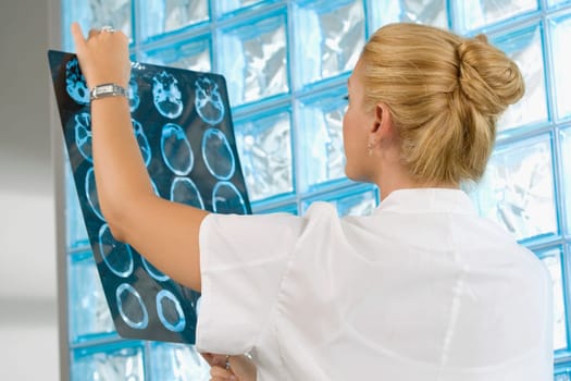 Female doctor examining an X_Ray report