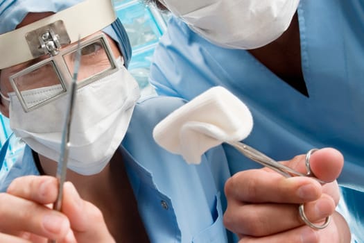 Two surgeons holding surgical scissors