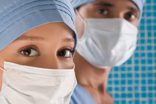 Close_up of a female doctor and a male doctor wearing surgical masks