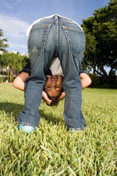 Rear view of a boy looking through his legs