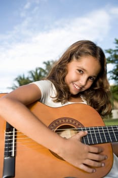 Portrait of a girl playing a guitar
