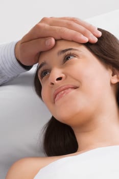 Close_up of a manŽs hand touching a young womanŽs head