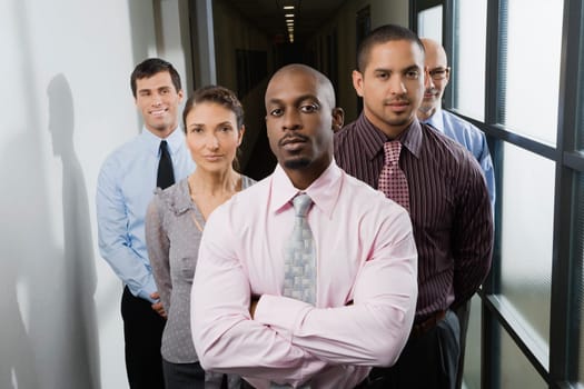 Business executives standing in a corridor