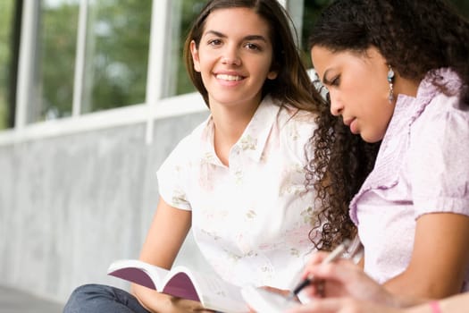 Two university students studying in a corridor
