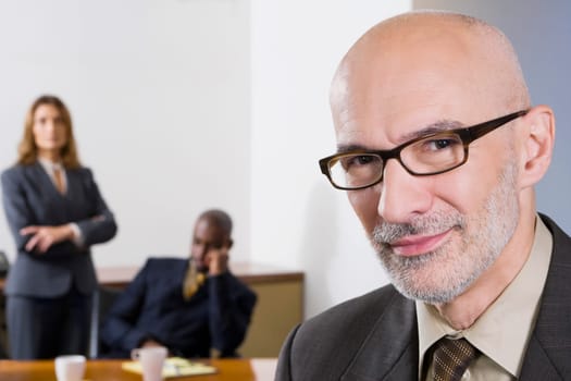 Portrait of a businessman with his colleagues in the background