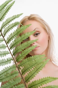 Portrait of a young woman holding a frond