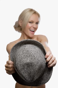 Portrait of a young woman holding a hat