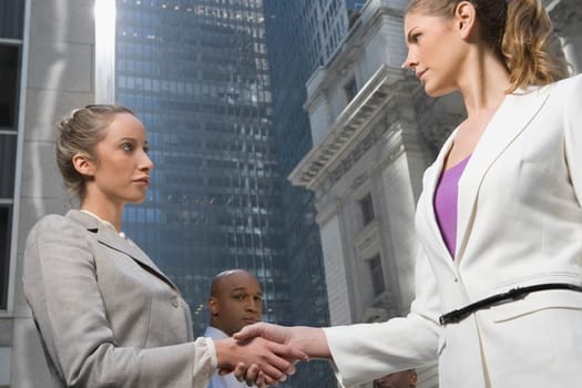 Low angle view of two businesswomen shaking hands