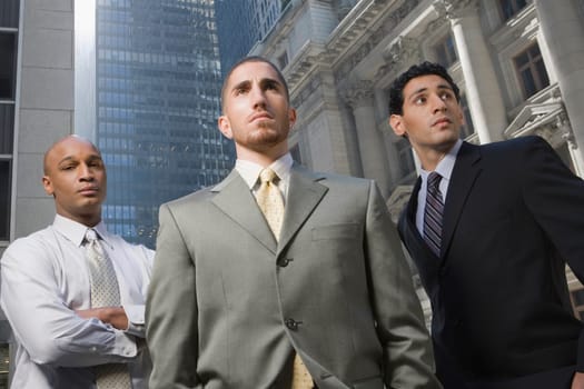 Low angle view of three businessmen standing