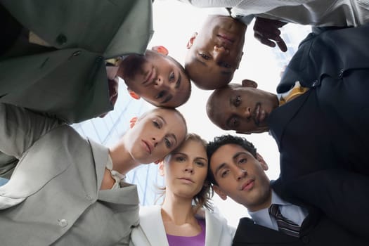 Low angle view of business executives standing in a huddle