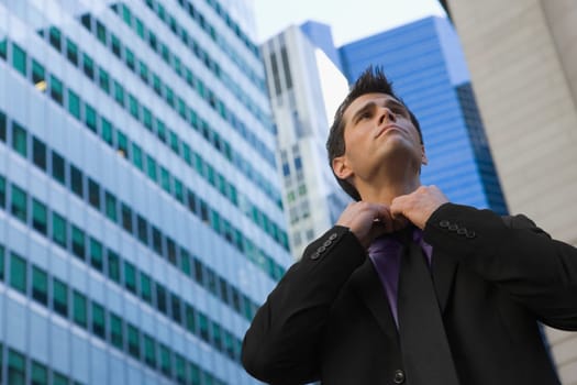 Low angle view of a businessman loosening his tie