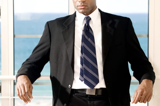 Close-up of a businessman leaning against a railing