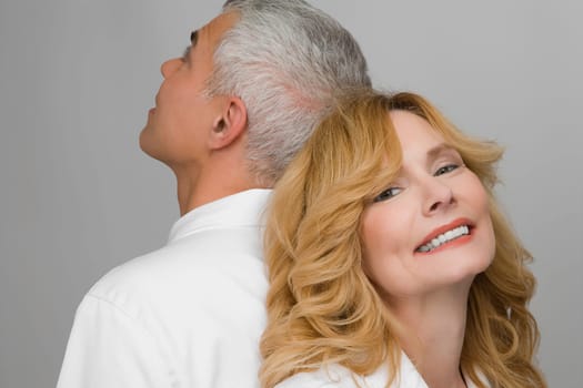 Close_up of a mature couple back to back
