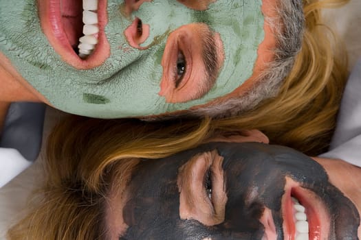Portrait of a mature woman with her daughter wearing facial masks and smiling