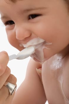 Close_up of a personŽs hand feeding baby food to a baby boy
