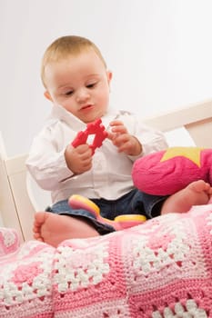 Close_up of a baby boy playing with a toy