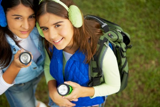High angle view of two mid adult women holding a flashlight
