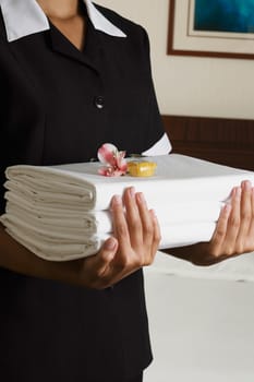 Candy, Close-Up, Color Image, Flower, Focus On Foreground, Front View, Holding, Indoors, Maid, Midsection, One Person, One Woman Only, Photography, Service Occupation, Serving, Sheet, Stack, Uniform, Vertical, Waitress, Assistance, Food And Drink, Prepara