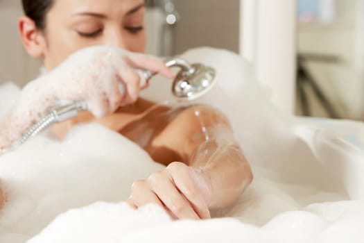 Close-up of a young woman taking a shower