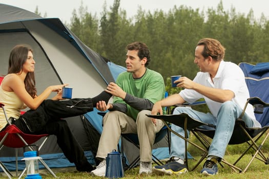 Mid adult woman and two mid adult men talking to each other