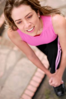 Close-up of a young woman stretching her leg