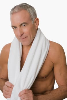 Portrait of a senior man smiling with a towel around his neck