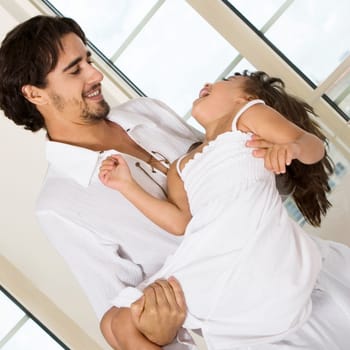 Close-up of a father carrying his daughter
