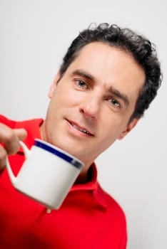 Portrait of a young man holding a tea cup