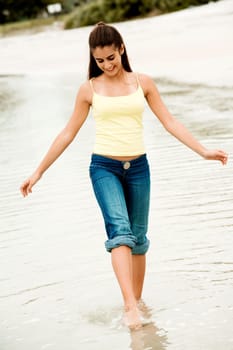 Girl wading in water on the beach