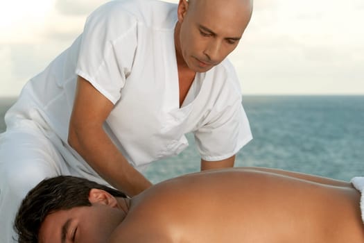Close-up of a massage therapist massaging a mid adult manŽs back
