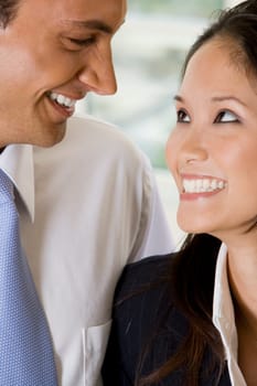 Close-up of a businessman and a businesswoman smiling
