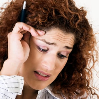 Close-up of a young woman with her hand on her head